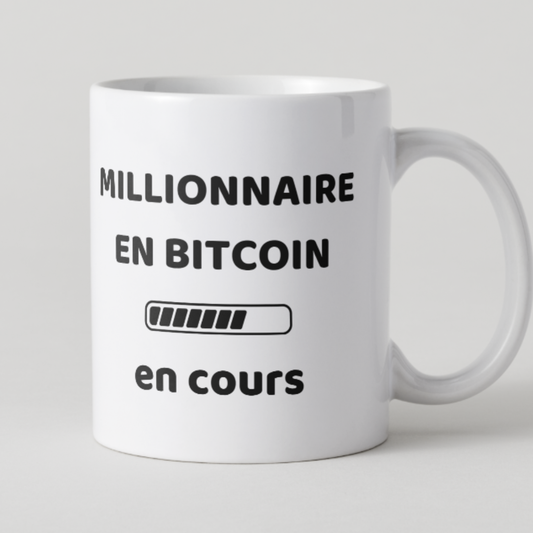 Mug blanc avec texte Millionnaire en Bitcoin en cours et design barre de chargement.